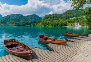 A view past boats along the shore of Lake Bled in Bled